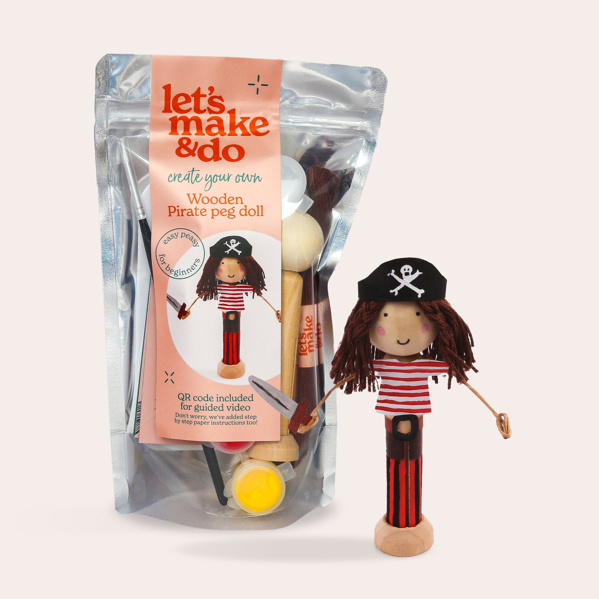 Wooden pirate peg doll with packaging labeled 'let's make & do' on a light pink background