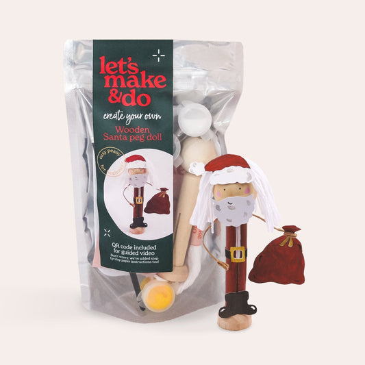Packaged wooden Santa craft kit with a white background