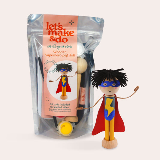 Superhero peg doll with packaging labeled 'let's make & do' on a light pink background
